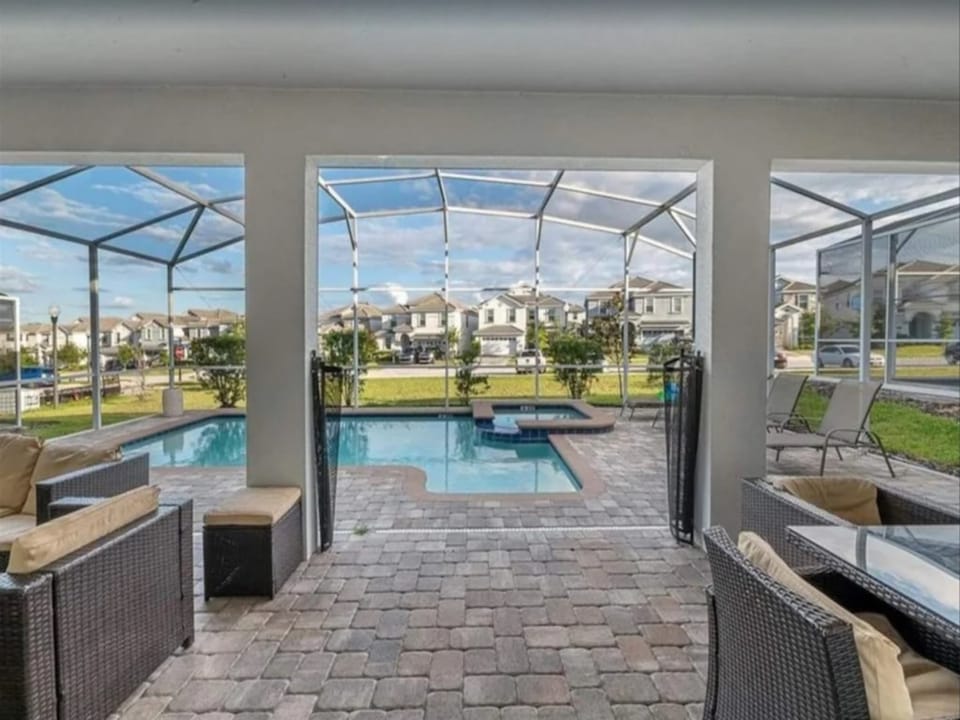 Stunning pool view from the screened patio, perfect for sunny days.