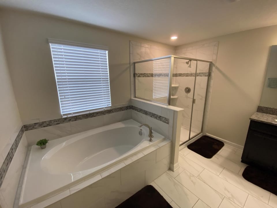 Spacious bathroom with a luxurious soaking tub and separate shower.