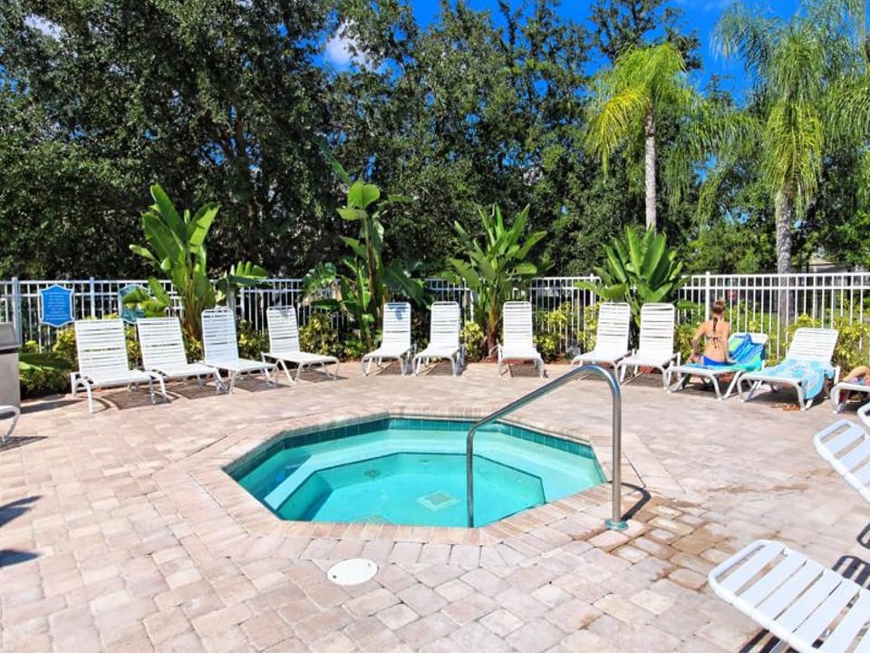 Relaxing hot tub surrounded by lush greenery for a serene outdoor experience.