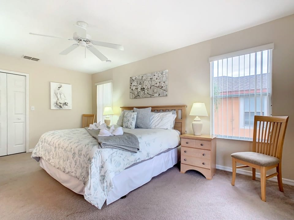 Bright and comfortable bedroom with plush bedding and ample natural light.