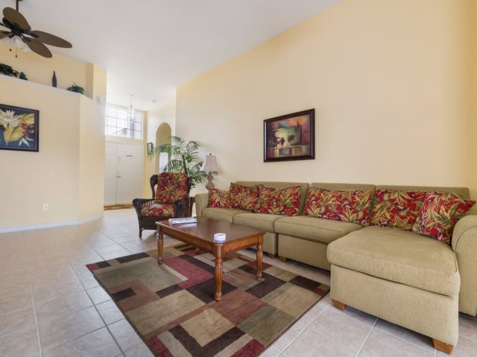 Spacious living area with colorful decor, a large sectional, and plenty of seating for everyone.