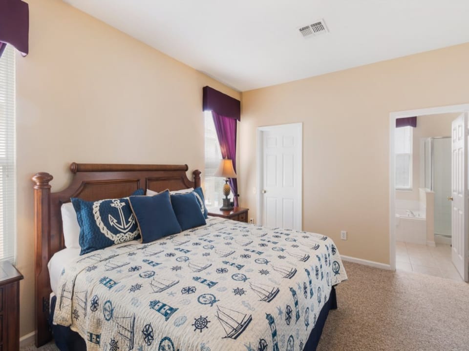 Nautical-themed queen bedroom with plush bedding and a relaxing ambiance.