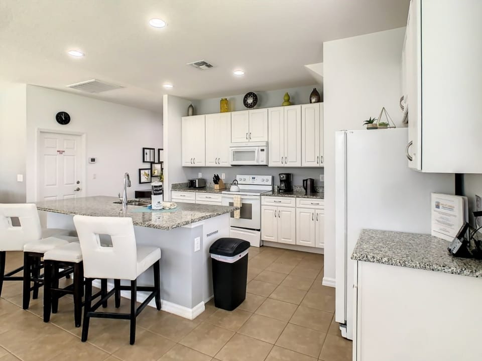 Bright and inviting kitchen with a breakfast bar and seating for casual meals.