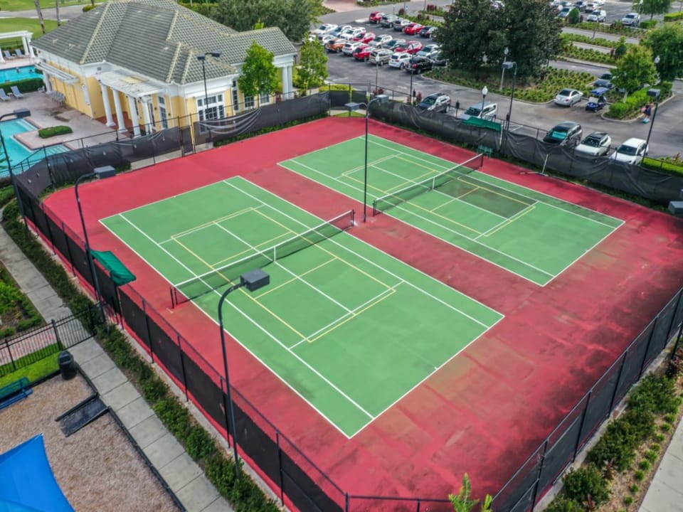 Multiple tennis courts with ample space for group activities and matches.
