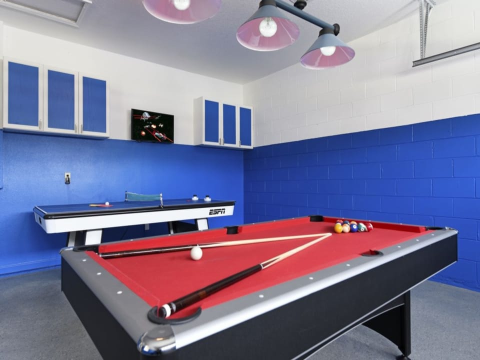 Fun-filled game room with pool table and entertainment setup.
