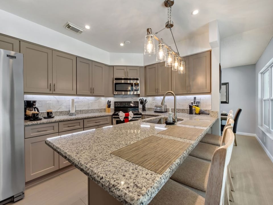 Modern kitchen with granite countertops, stainless steel appliances, and ample space for cooking.