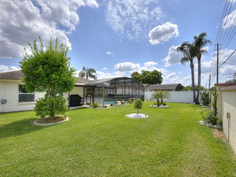 Expansive backyard with ample space for relaxation or play under sunny skies.