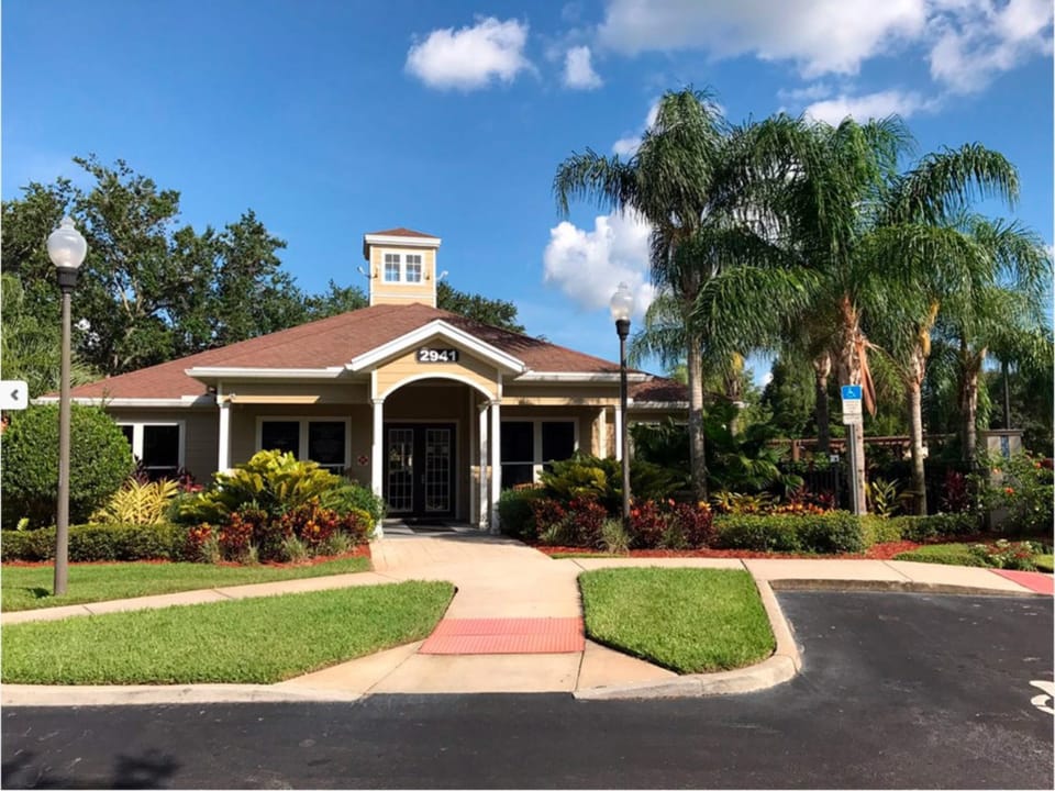 Elegant clubhouse entrance with beautiful landscaping and a welcoming vibe.