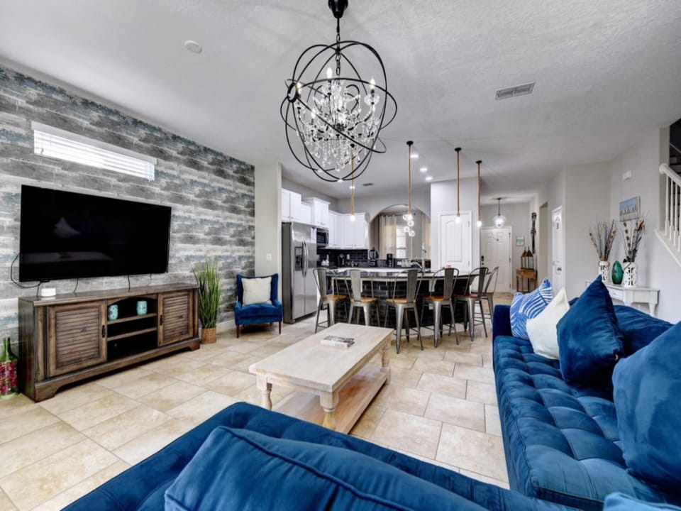 LEISURE ROOM:  Living Room Area with Sofa that seats between 4-5 people, 2 Accent Chairs and 65” Flat-Screen TV