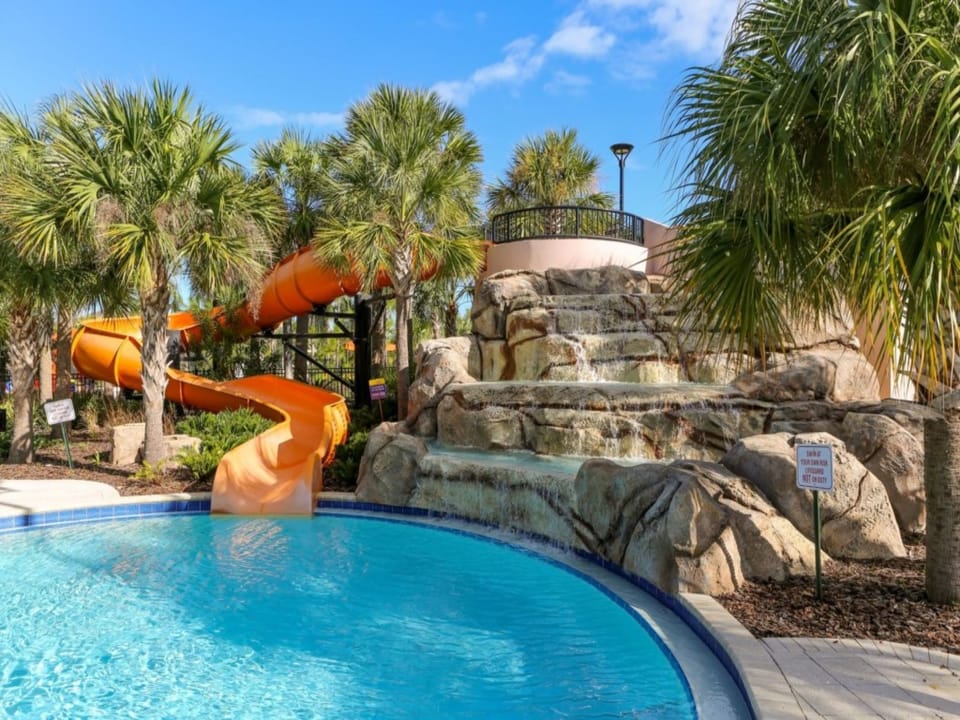 Resort pool with cascading waterfalls and vibrant water slides for endless enjoyment