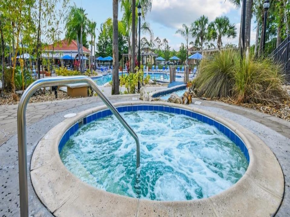 Relaxing hot tub surrounded by lush palm trees for ultimate tranquility.