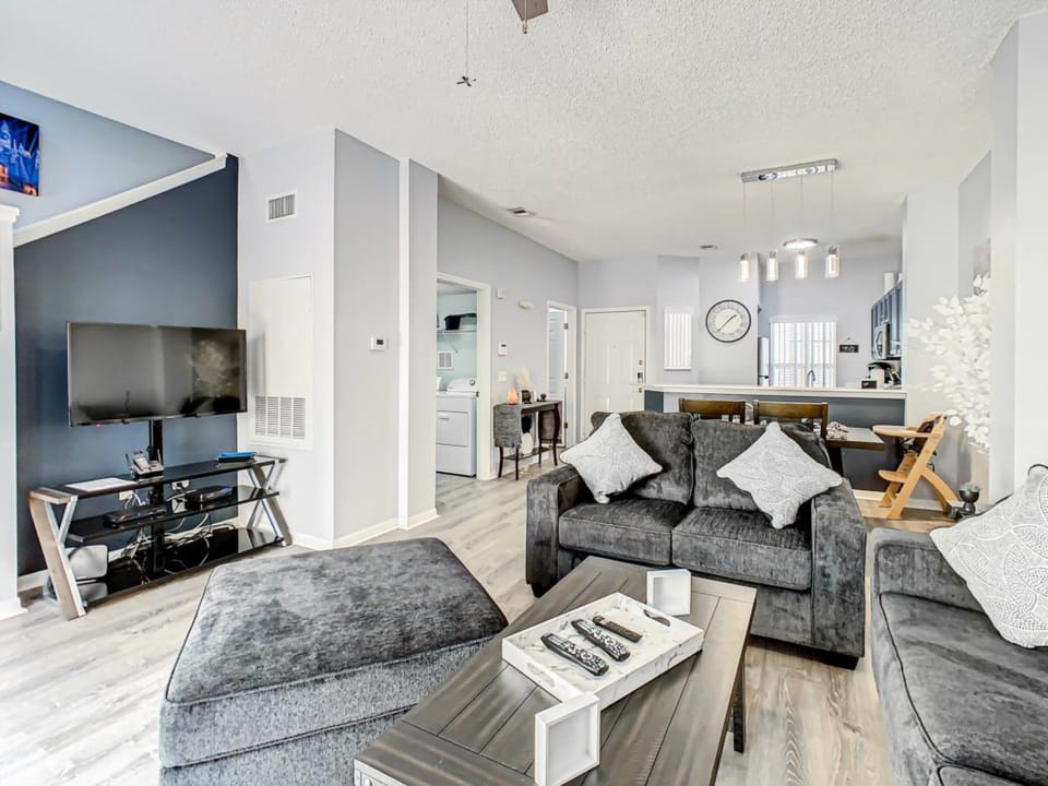 Spacious living area with cozy seating and modern decor, perfect for relaxing after a day of exploring.