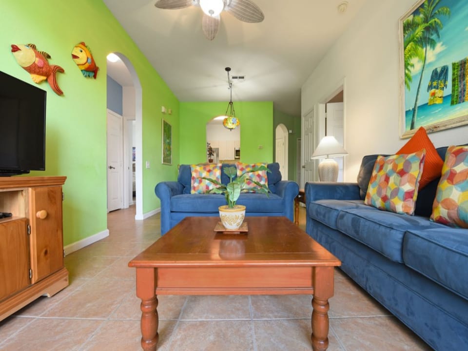 Open-concept living space with stylish decor, ample seating, and vibrant colors for a welcoming vibe.