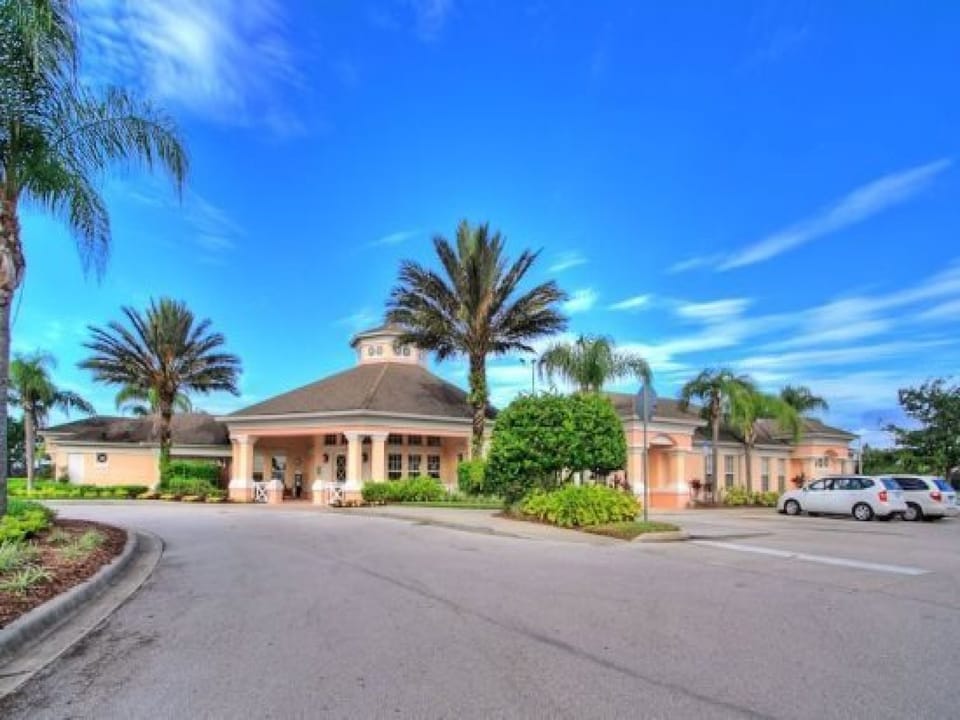 Beautiful community entrance with lush landscaping and a welcoming clubhouse.