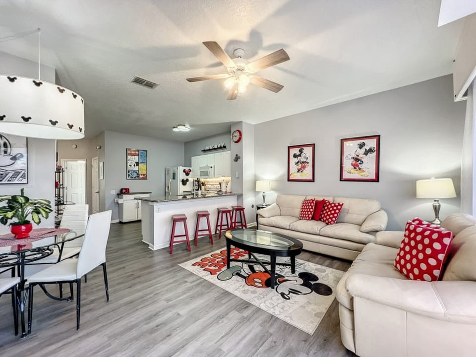 Bright and open living space with Disney accents and cozy seating for relaxation.