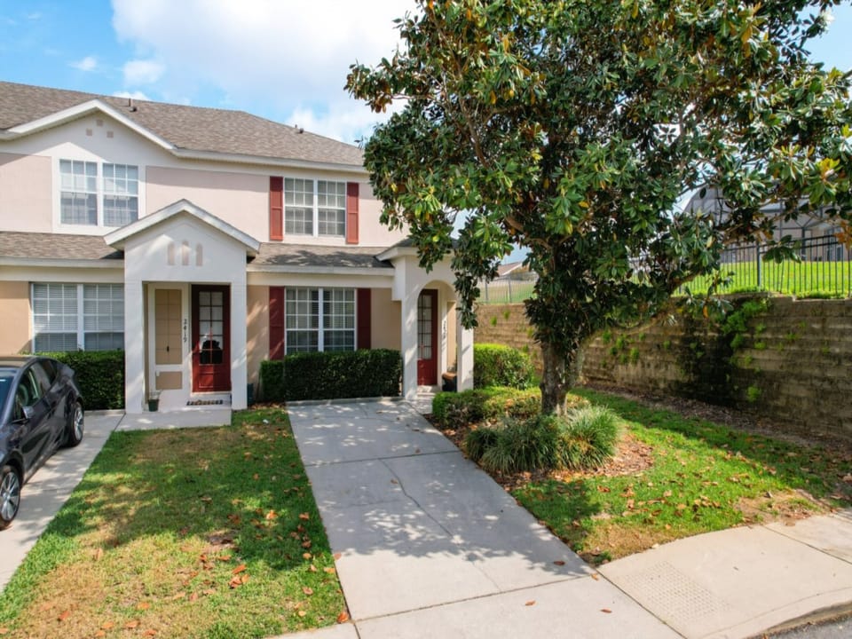 Charming front exterior with a lush green yard and inviting curb appeal.