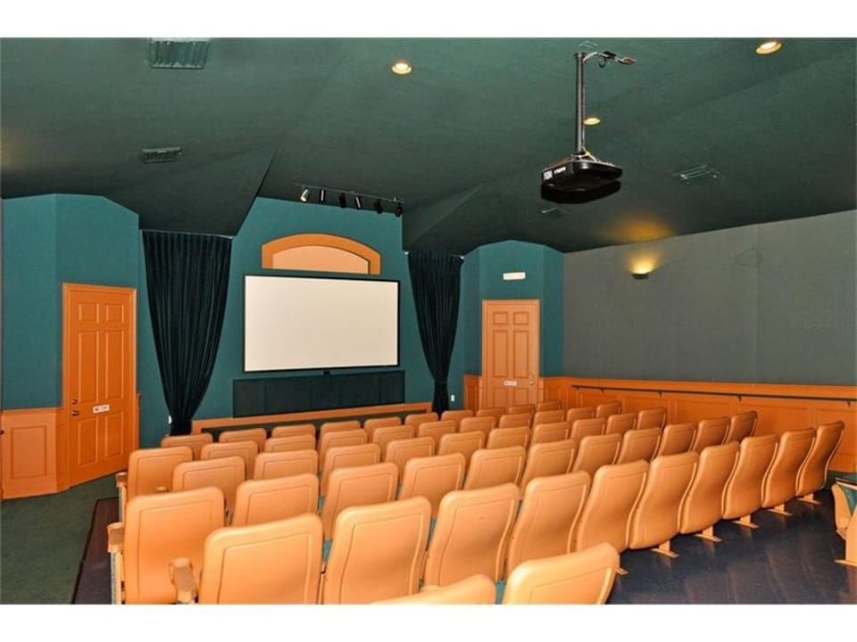 Cozy theater room with comfortable seating for movie nights or presentations.