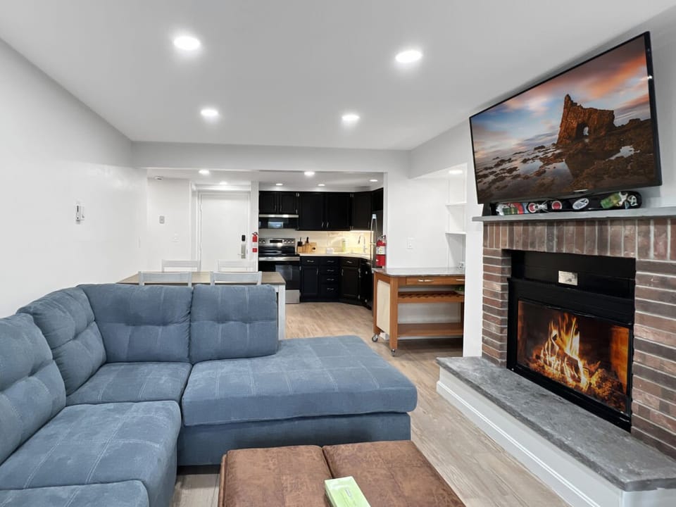 living room with large tv and electric fire place