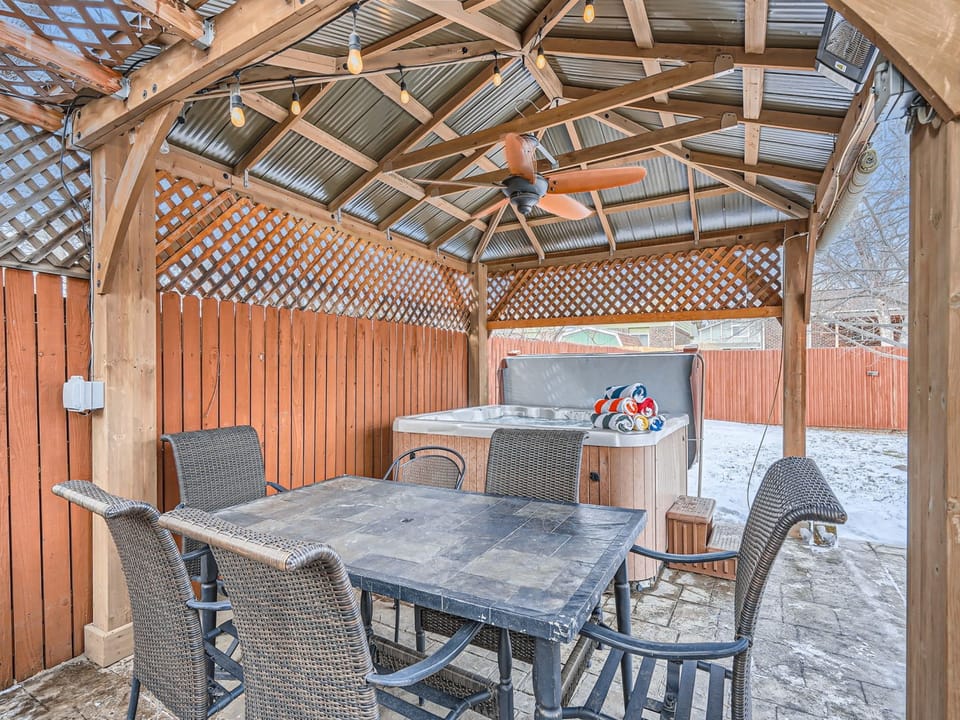 Step outside to the covered patio, complete with seating for six and a private hot tub - perfect for outdoor dining or relaxation.