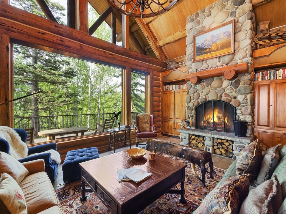 Beautiful Great room with high ceilings, wood burning fireplace and Large flat screen TV for entertainment.