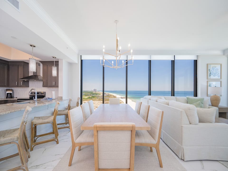 Gather around the elegant dining table with stunning beach views that invite relaxation and connection