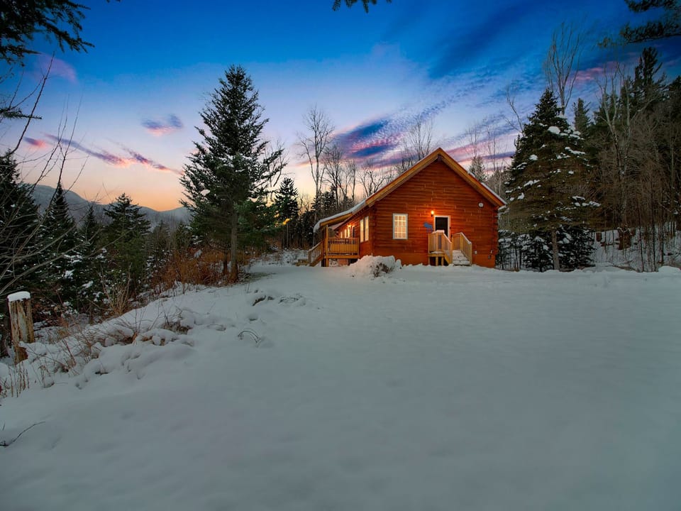 Modern log cabin nestled in a stunning natural setting, blending comfort with rustic charm.