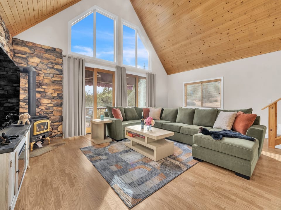 Living Room area showing gas stove for chilly winter months and oversized sliders that lets in lots of natural sunlight