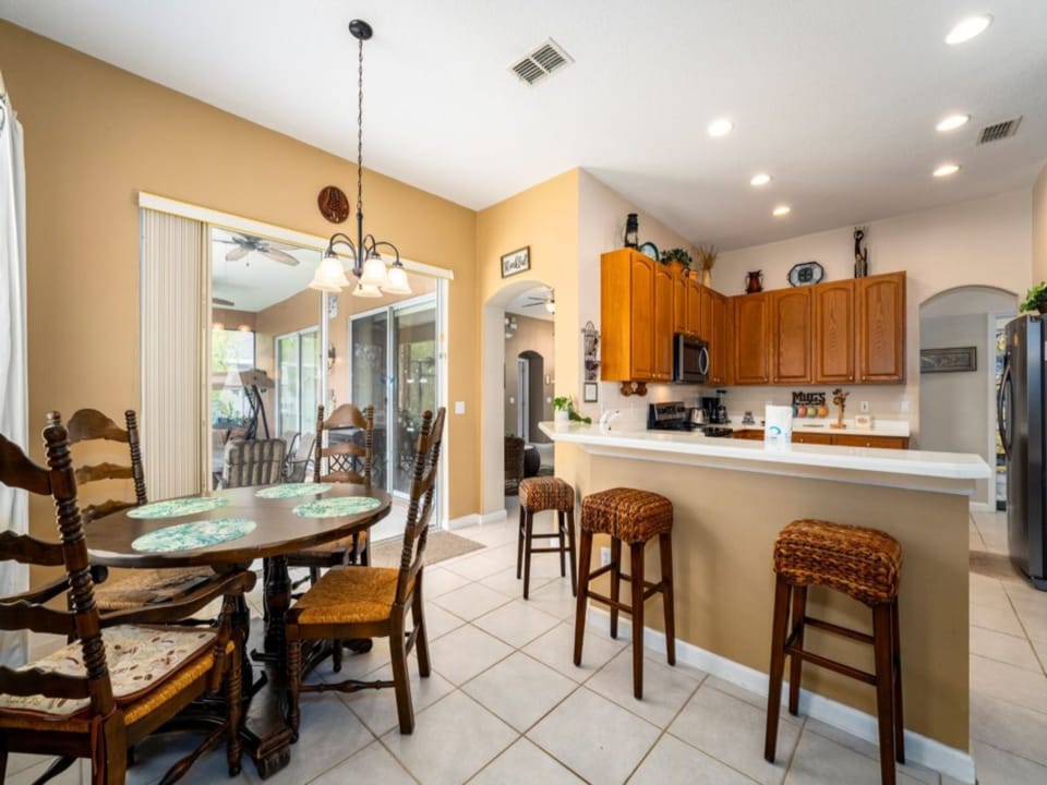 KITCHEN: 3-Seat Breakfast Bar and Eat-In-Kitchen with 4-Seat Dining Table,  Direct Access to Pool/Patio Area