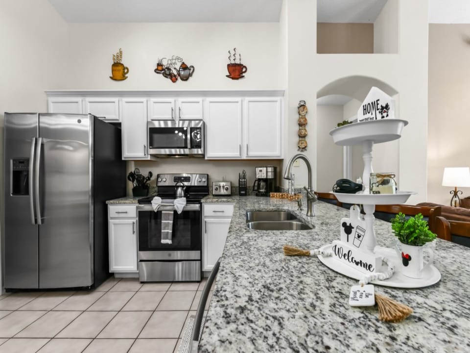 Kitchen Area with Refrigerator, Microwave Oven, Gas stove, Coffee Maker, Kitchen Utensils, and Kitchen wares