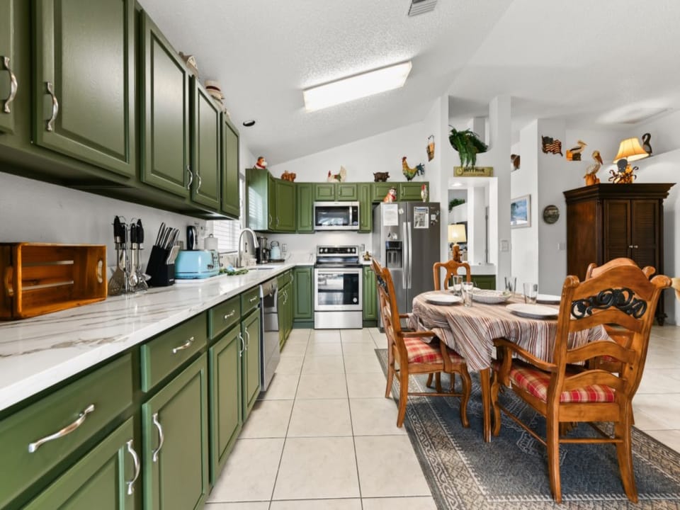 Kitchen Area with Refrigerator, Microwave oven, Stove, Coffee Maker, Electric Kettle, Kitchen utensils, and Kitchenwares