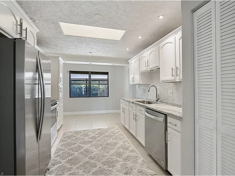 Modern kitchen with stainless steel appliances - kitchen furniture being added