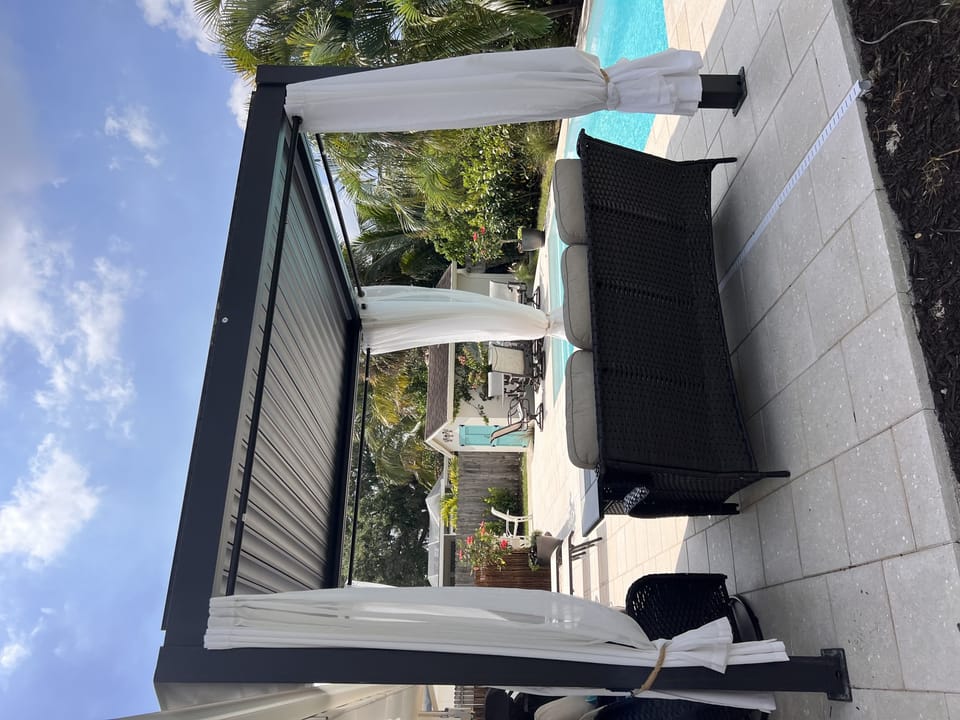 Gazebo with privacy curtains and seating