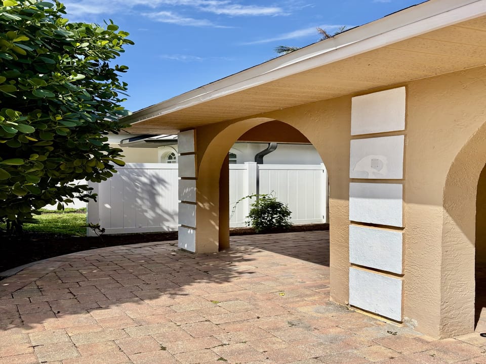 Covered entrance and side gated access to back yard