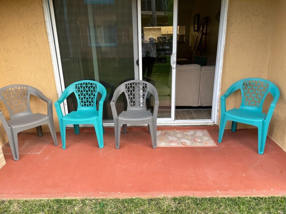 Patio with mix-colored chairs, perfect for a relaxing outdoor gathering.