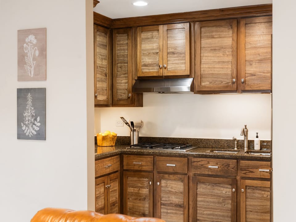 Fully equipped kitchen with wooden cabinets.