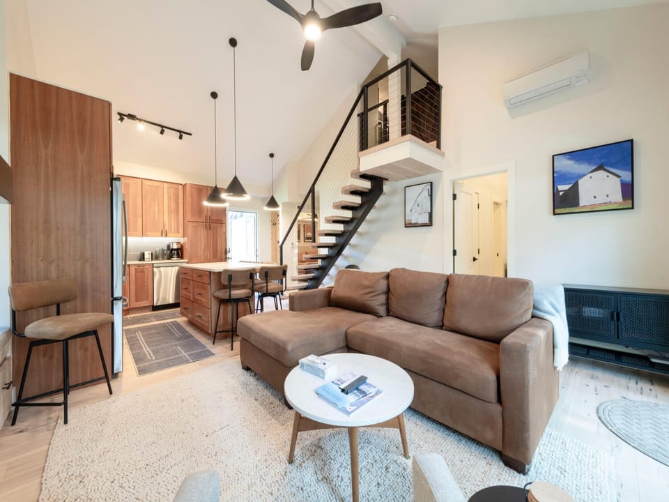 Open kitchen with new appliances & island seating.