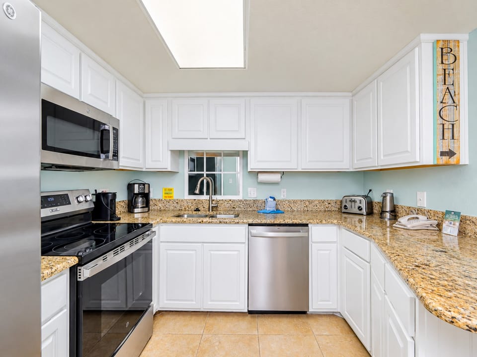 Gather around the dining table with friends, surrounded by coastal decor and inviting seating in this airy space