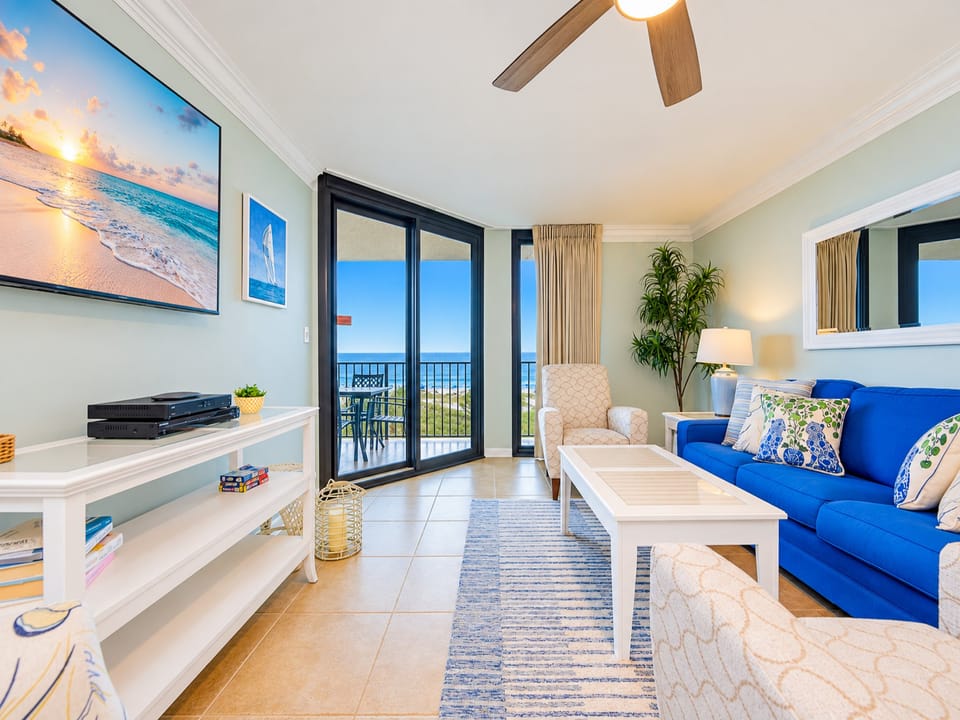 Unwind in this inviting living area with comfortable seating and a large TV, all while enjoying views from the balcony