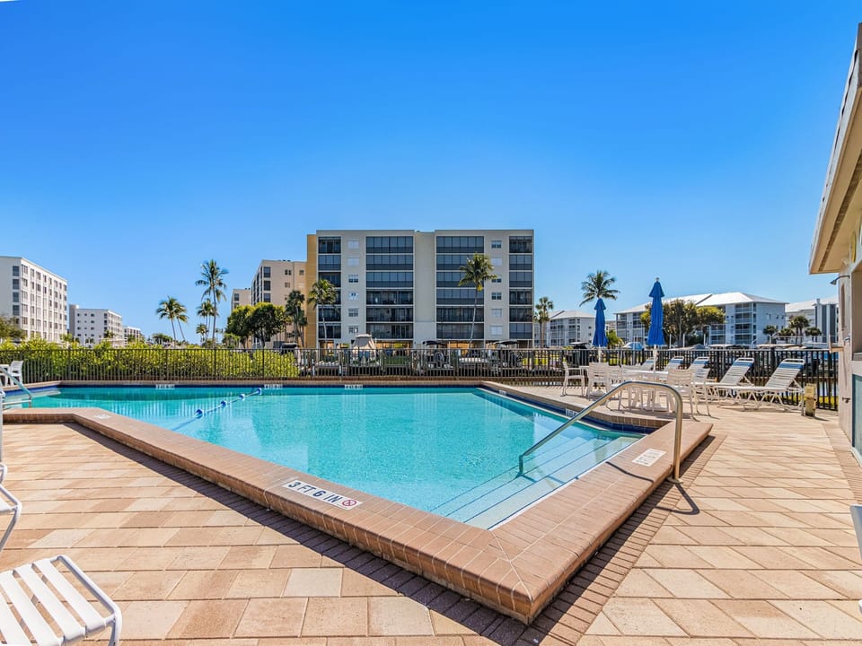 Beautiful Community Pool with Sun Loungers and Umbrellas