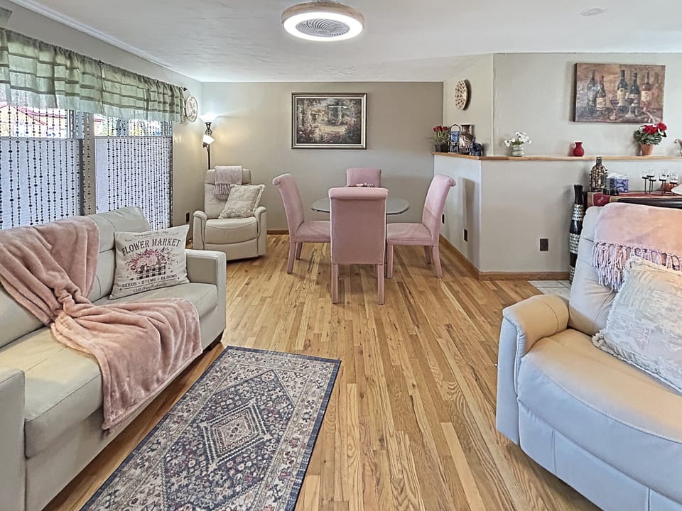 Unwind in your bright, open living space where plush sofas invite relaxation and the elegant dining area sets the scene for memorable meals together.