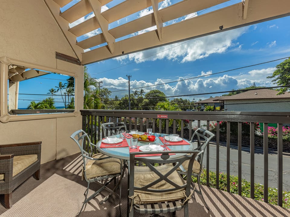 Serene lanai seating with greenery all around