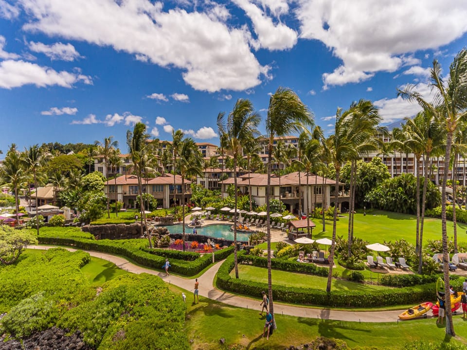 Aerial view of the resort’s sparkling pool and lush grounds