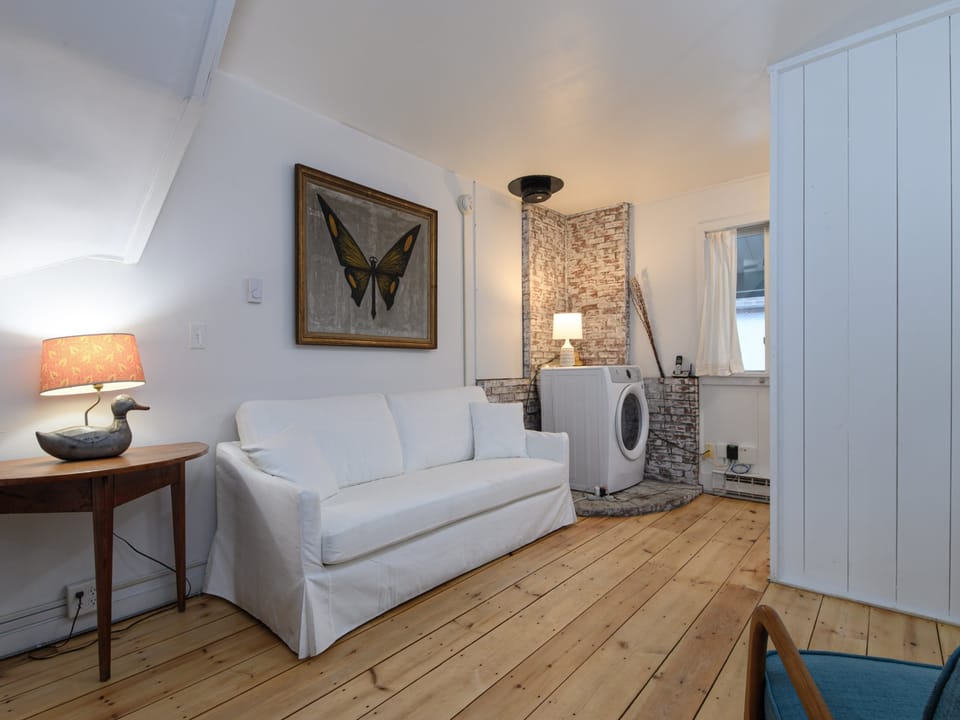 Relax in a bright living area with warm wood floors and inviting comfort.