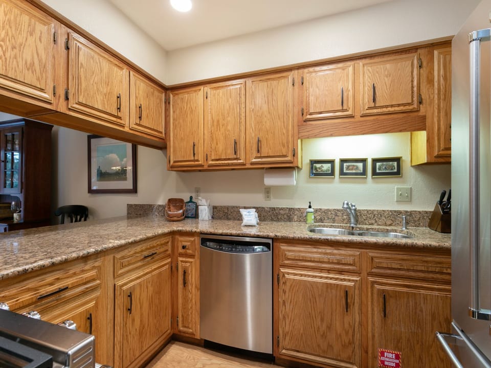 Your fully equipped kitchen features granite countertops, stainless steel appliances, and beautiful oak cabinetry, making meal preparation a pleasure during your stay.