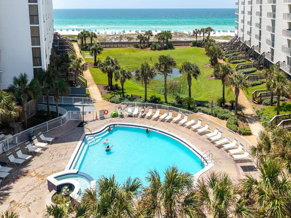Take a refreshing dip in the sparkling pool, then relax on a lounge chair as you gaze across the lush grounds to the turquoise waters and white sand beach just beyond.