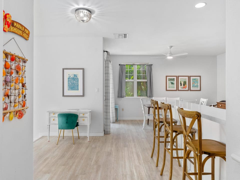Your bright, open dining space blends modern comfort with charming details—from the cozy breakfast bar to thoughtful artwork throughout.
