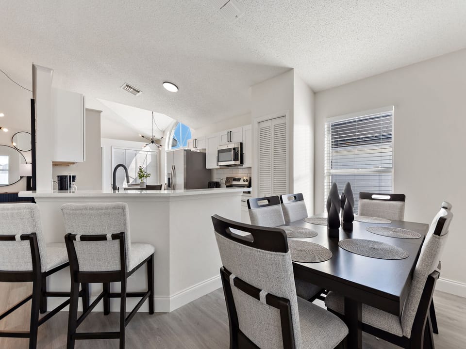 Family dining area with seating for six and view of the pool