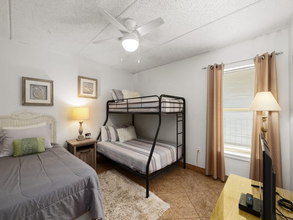 Guest bedroom with a twin bed and twin-over-full bunk, ideal for families or groups