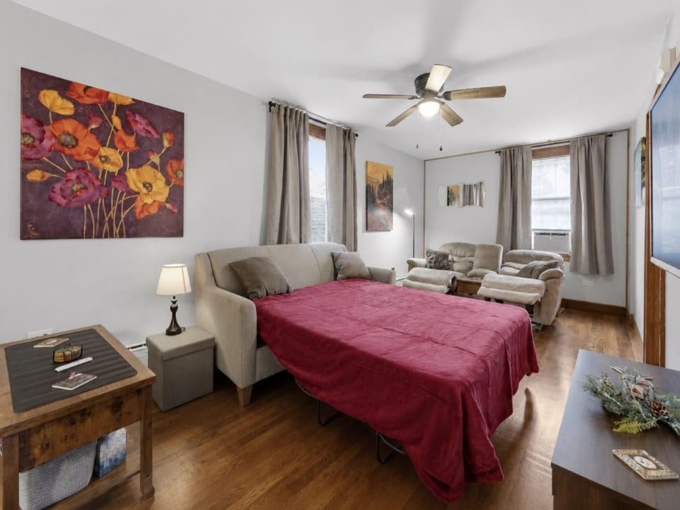 Spacious living room w/sofa bed, 2 reclining chairs, and large smart TV, with easy access to the downstairs bathroom. Upholstered chairs from the dining room can be easily moved into this space when 6 guests are present.
