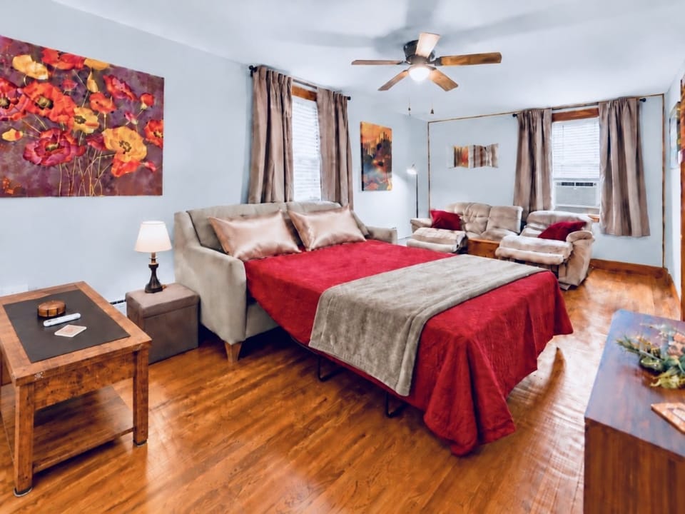 Spacious living room w/sofa bed, 2 reclining chairs, and large smart TV, with easy access to the downstairs bathroom. Upholstered chairs from the dining room can be easily moved into this space when 6 guests are present.